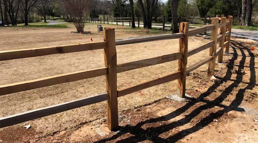 Western Red Cedar privacy fence set 36 inches deep in concrete in Independence, MO — RKC Wood Care Pros