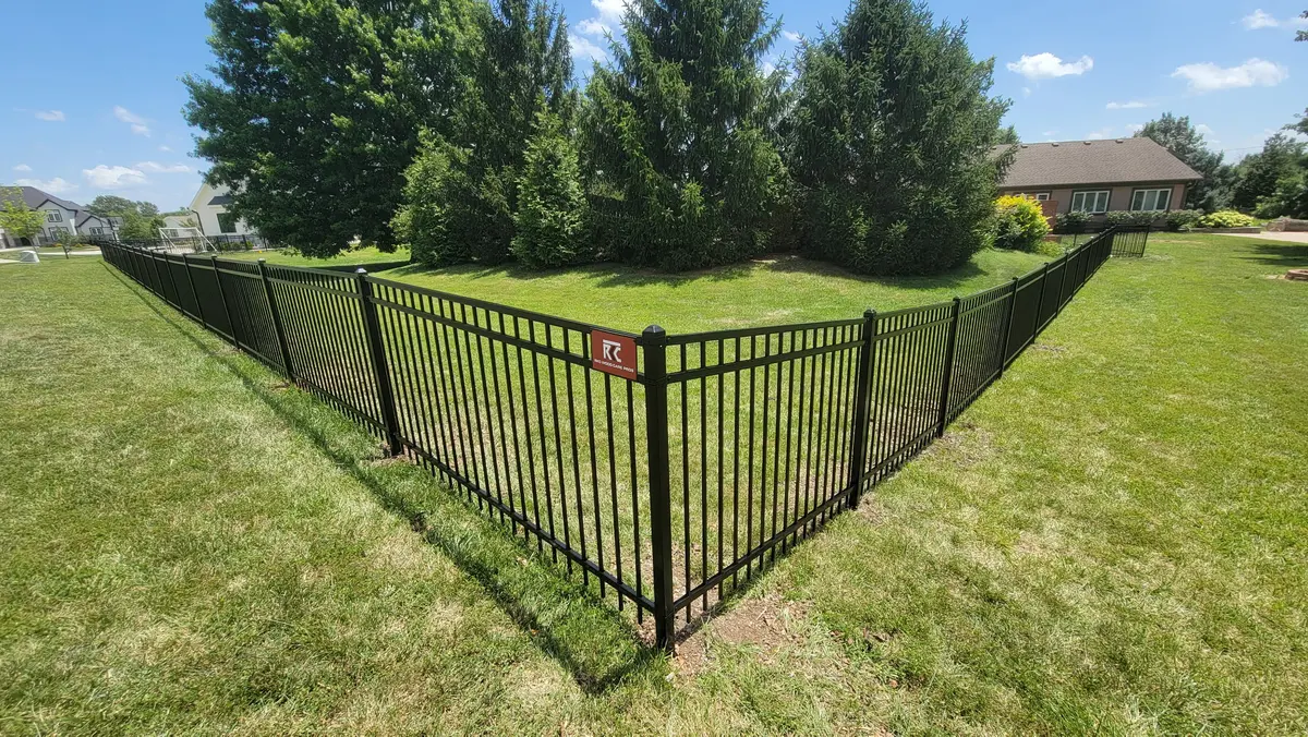 Black aluminum ornamental fence installed around an open backyard in the Kansas City metro by RKC Wood Care Pros
