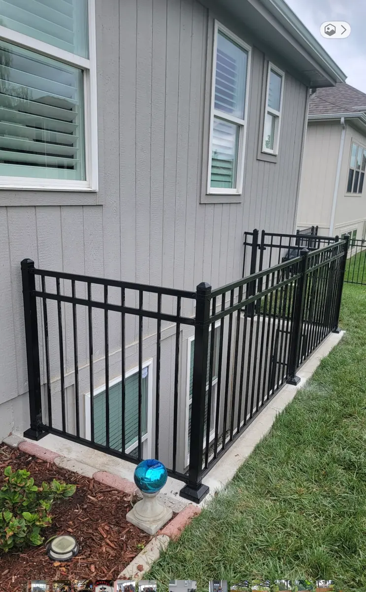 Black aluminum fence panels and gate screening equipment beside a home by RKC Wood Care Pros
