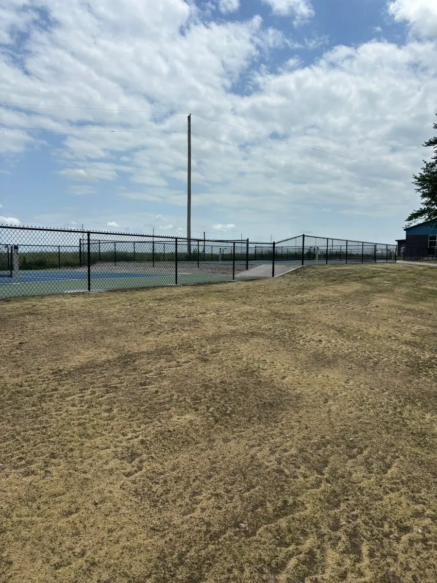 Black chain link fence enclosing a sport court by RKC Wood Care Pros