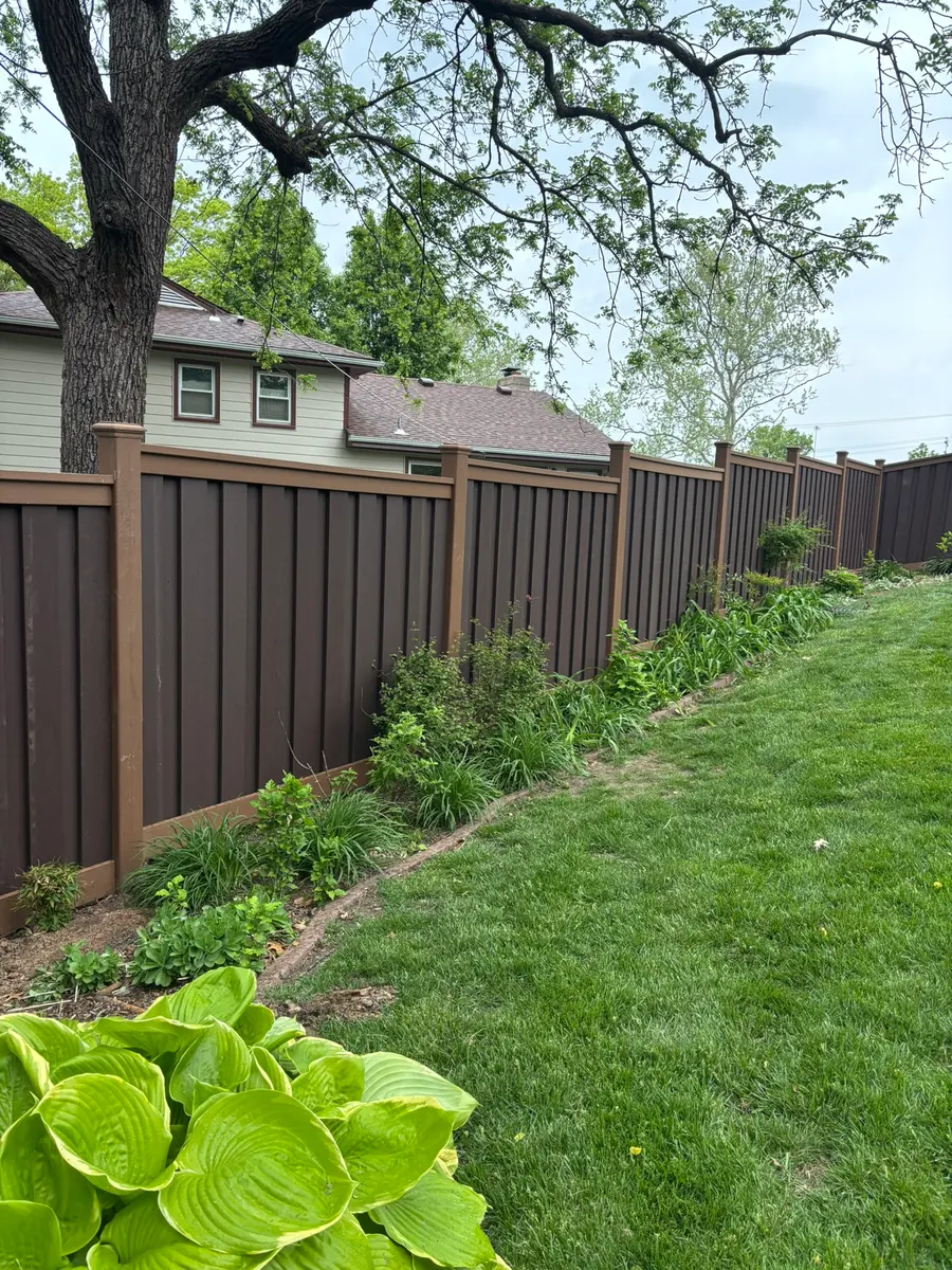 Brown composite privacy fence with cedar-tone posts installed by RKC Wood Care Pros