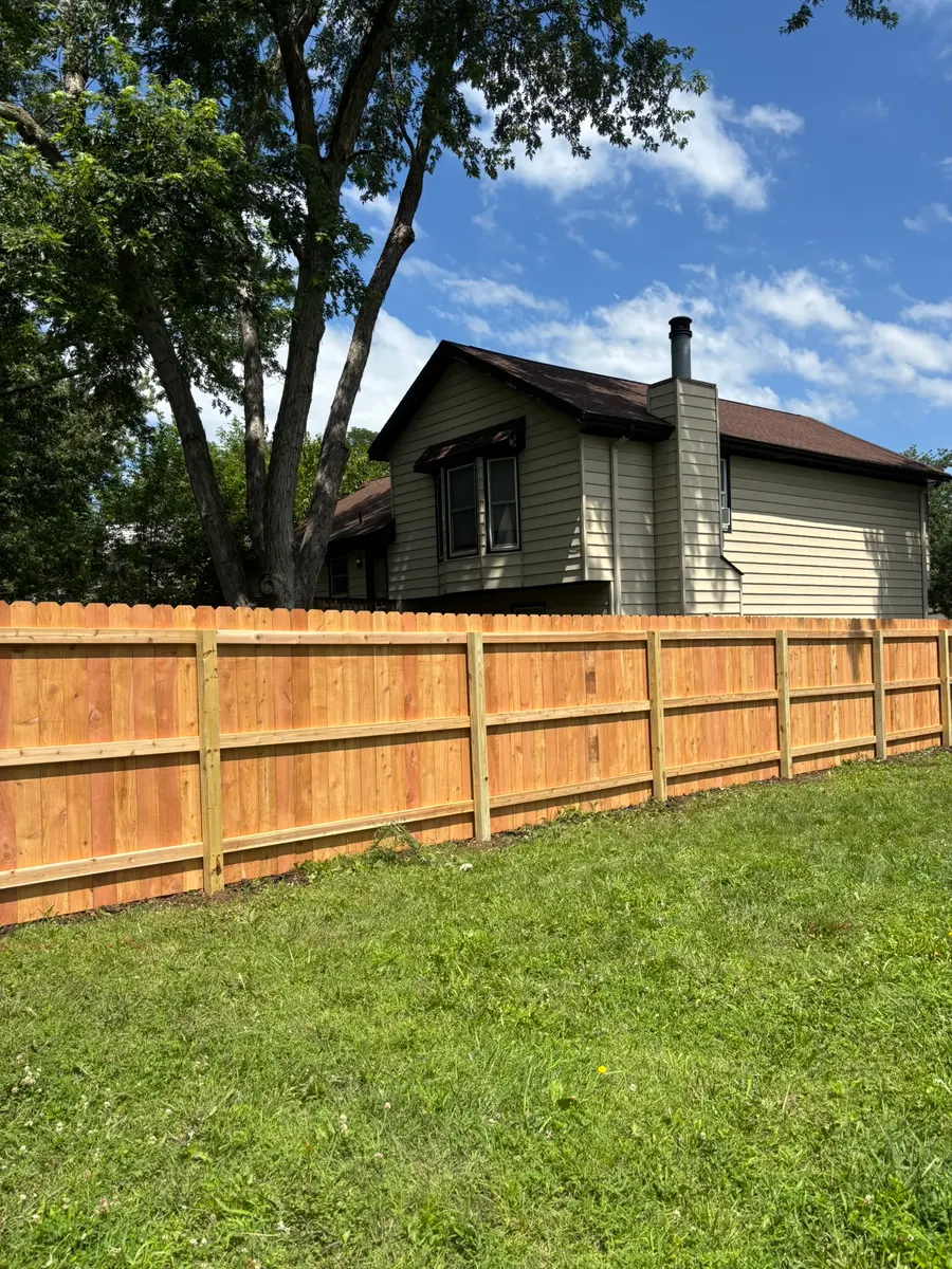 Cedar privacy fence running the full backyard perimeter of a Kansas City metro home by RKC Wood Care Pros