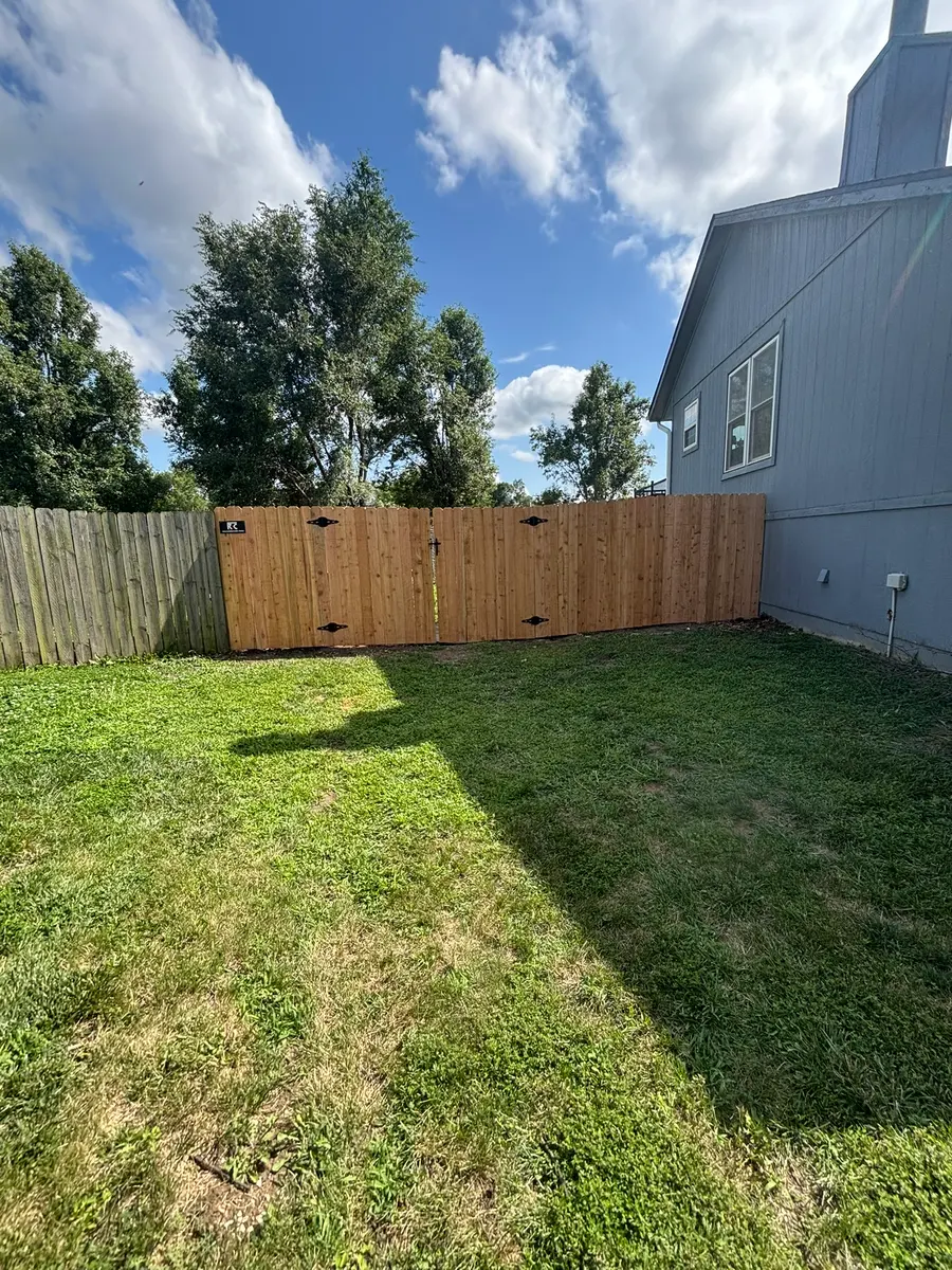 Cedar privacy fence with a double drive gate for yard access by RKC Wood Care Pros