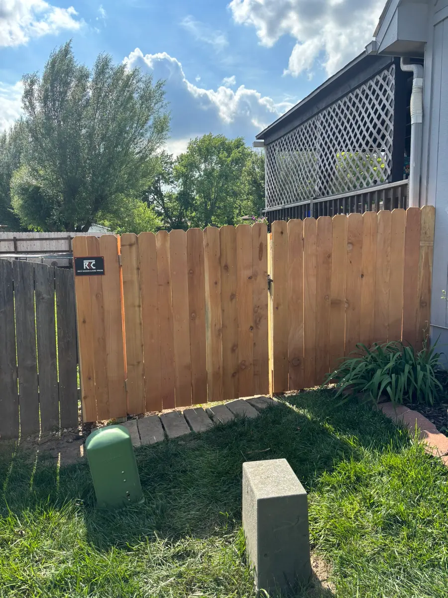 Cedar privacy fence and walk gate closing off a side yard by RKC Wood Care Pros