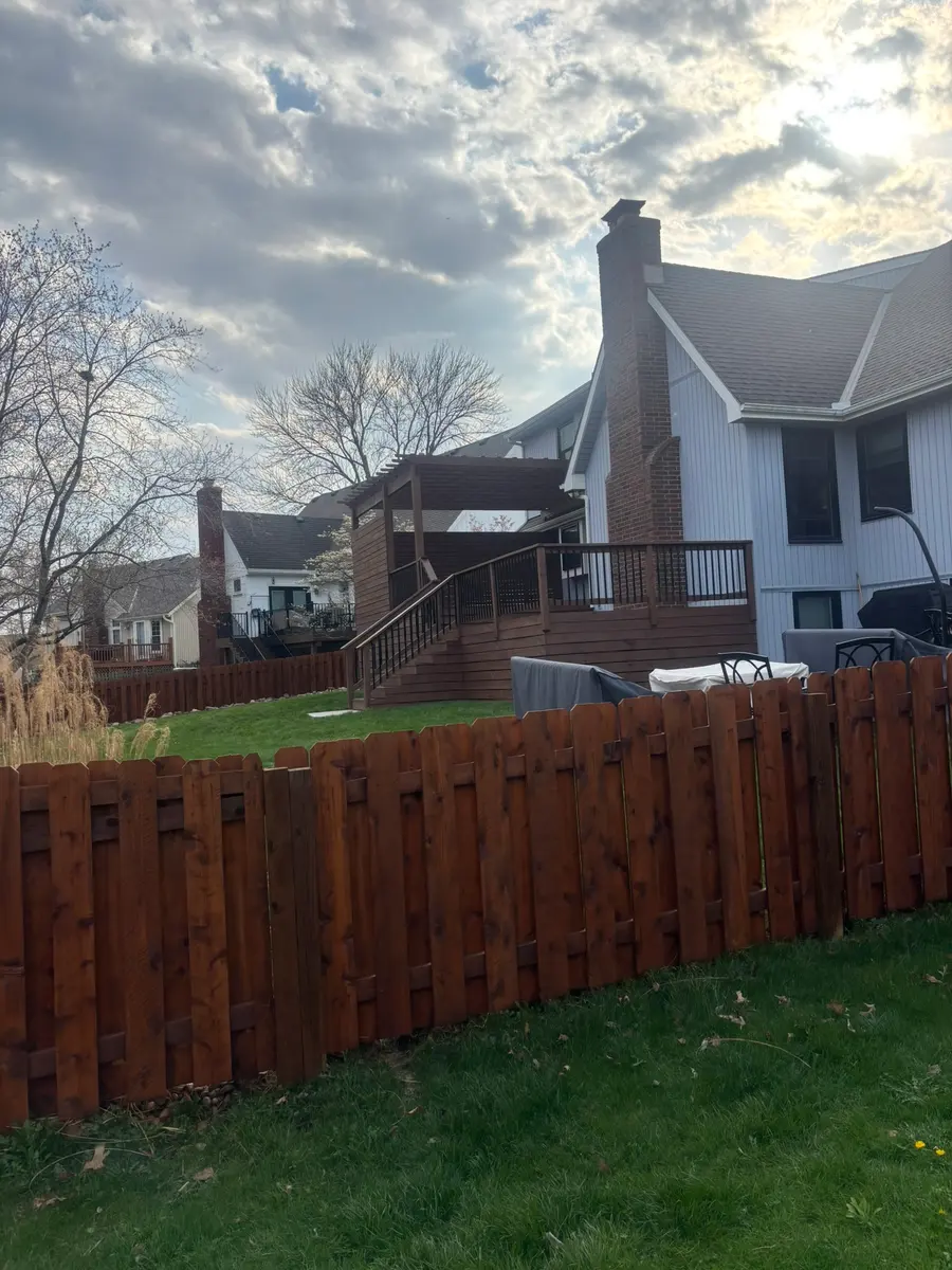 Cedar privacy fence sealed with a dark stain behind a Kansas City metro home by RKC Wood Care Pros