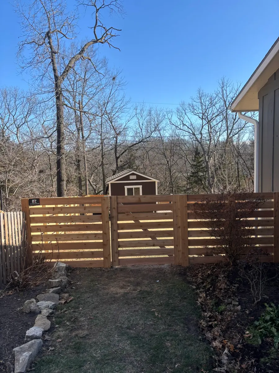 Horizontal cedar fence with a matching walk gate built by RKC Wood Care Pros