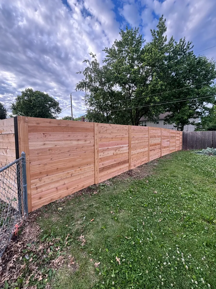 Horizontal cedar privacy fence replacing an old chain link fence line by RKC Wood Care Pros