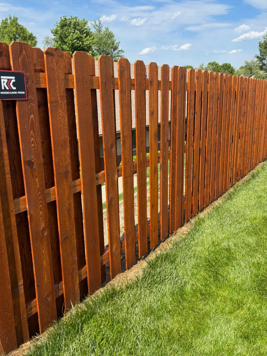 Close-up of a cedar shadow box fence finished with a rich brown stain by RKC Wood Care Pros
