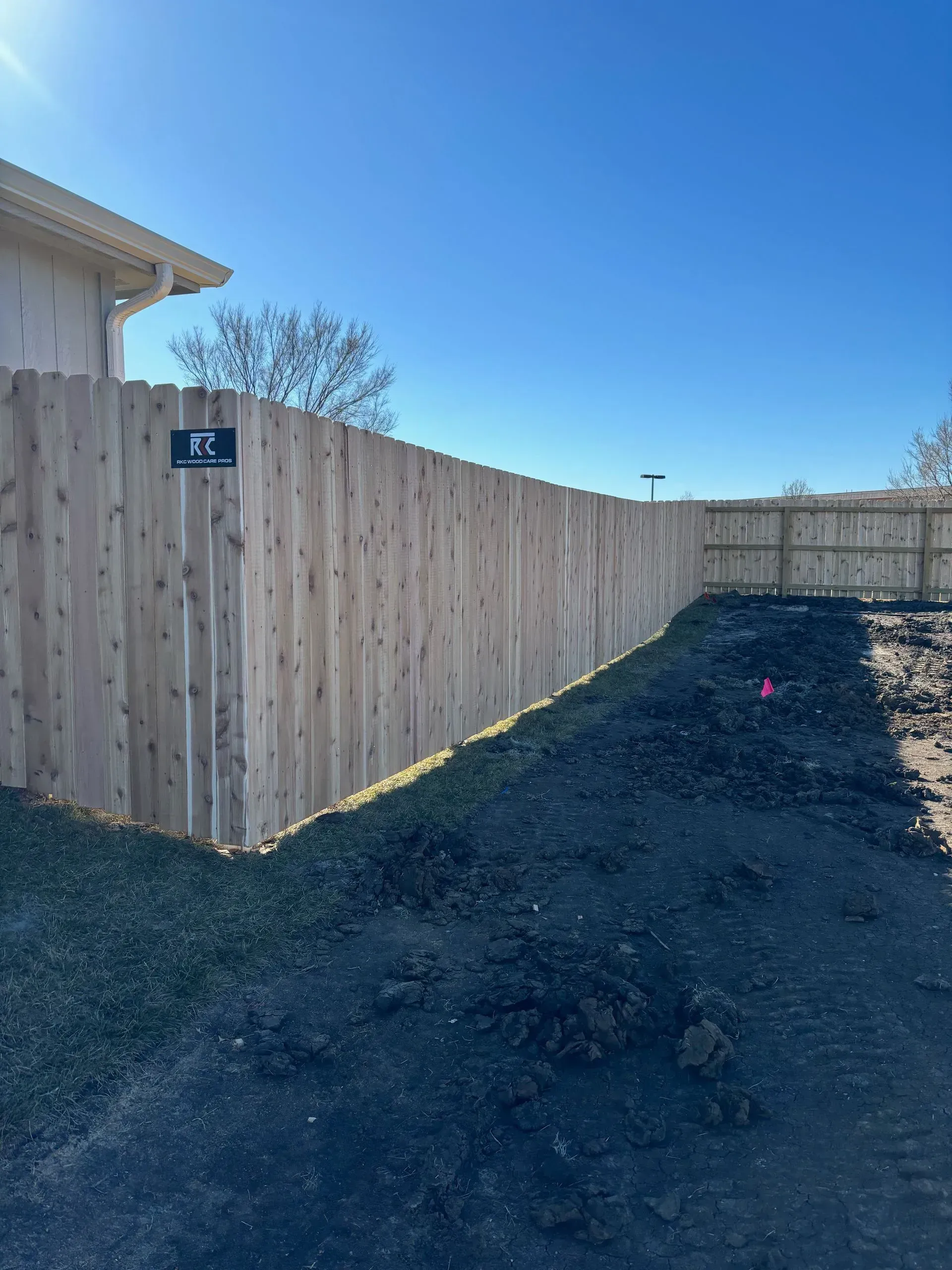 RKC Wood Care Pros crew installing a cedar privacy fence in Olathe, KS