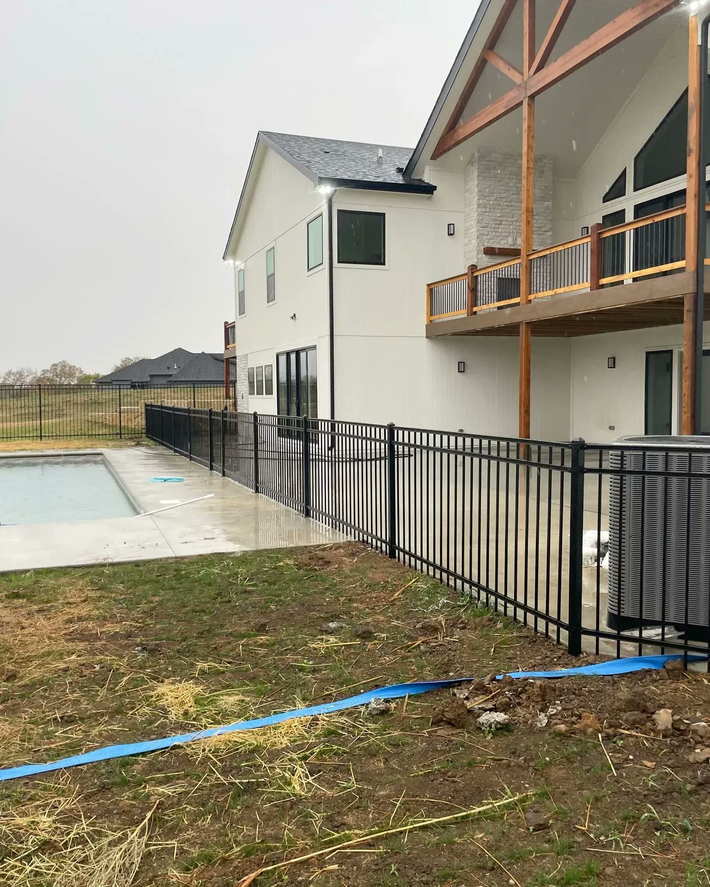 Ornamental aluminum fence with puppy panel bottom section in Shawnee, KS — RKC Wood Care Pros