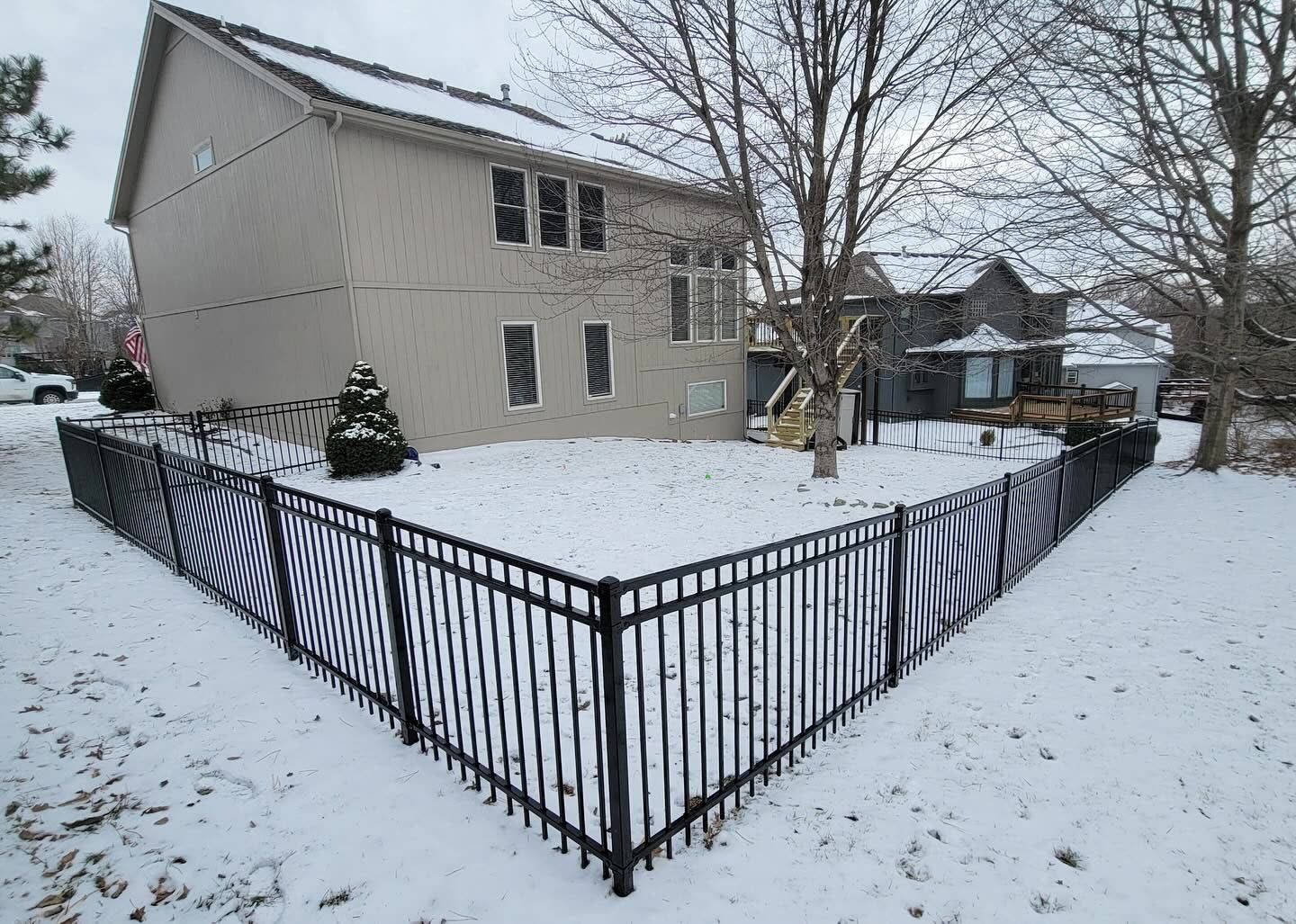 Two-rail ornamental aluminum fence with flat-top pickets in Kansas City, MO — RKC Wood Care Pros