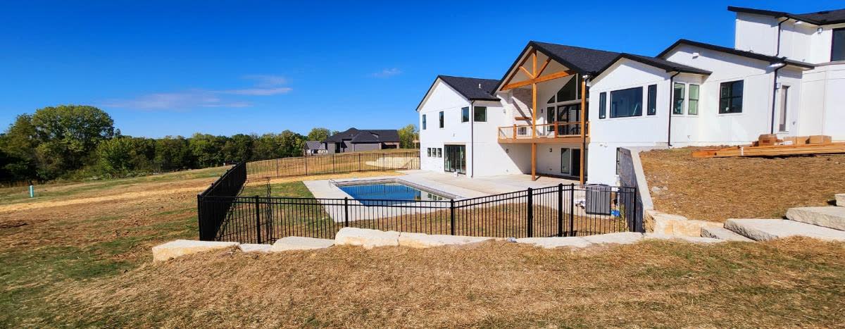 RKC Wood Care Pros crew installing pool-code aluminum fence with self-closing gate and 36-inch post depth