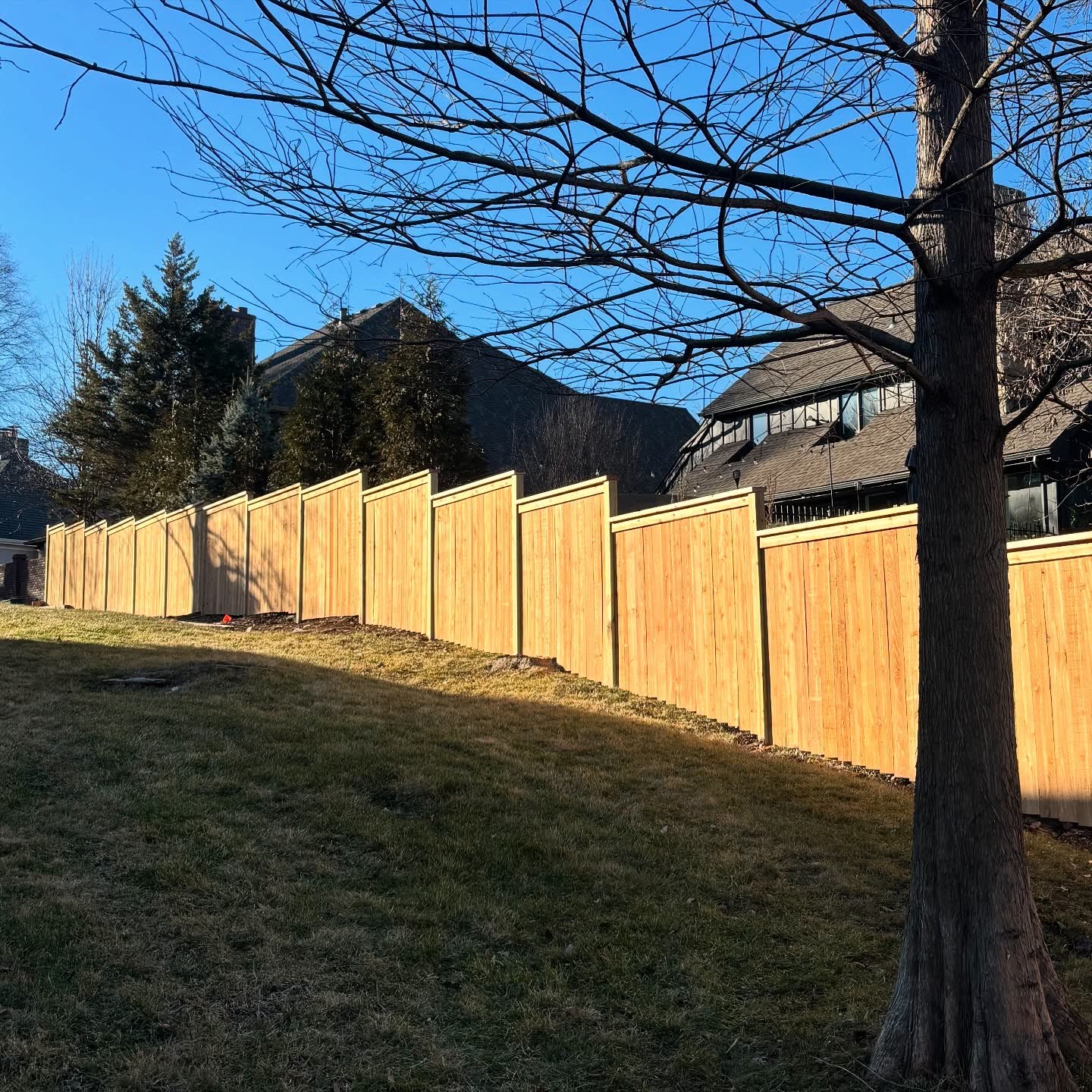 RKC Wood Care Pros crew setting a privacy fence post 36 inches deep in poured concrete, 6 feet on center in Kansas City