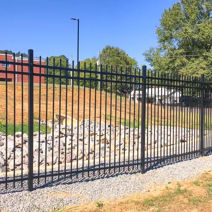 Black steel ornamental fence with spear-top finials at a Kansas City school — RKC Wood Care Pros