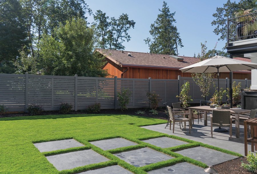 Gray horizontal vinyl fence with modern patio setting in Kansas City — RKC Wood Care Pros