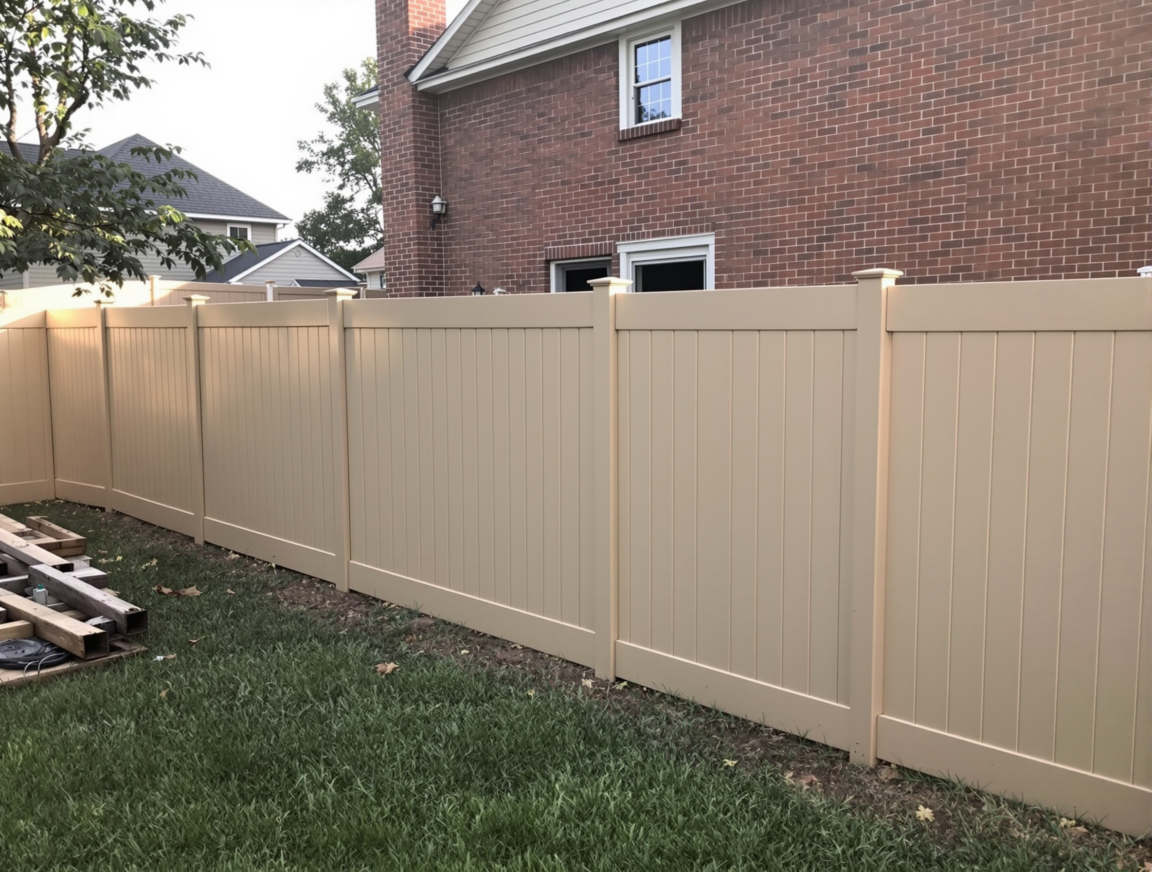 Sand-tan vinyl privacy fence in a Kansas City backyard by RKC Wood Care Pros