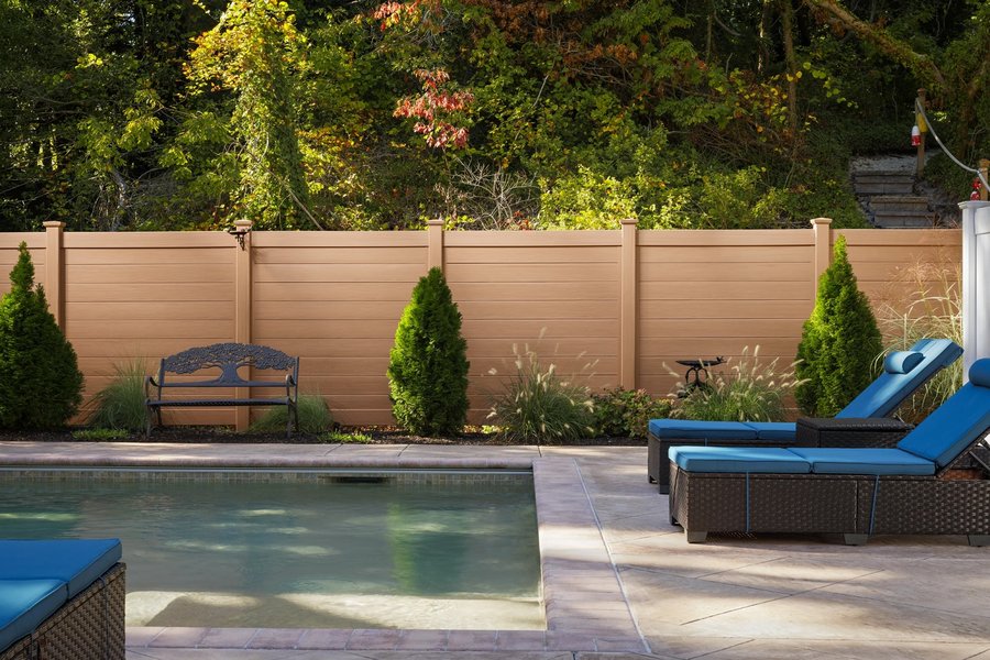Tan vinyl privacy fence around a backyard pool in Kansas City — RKC Wood Care Pros