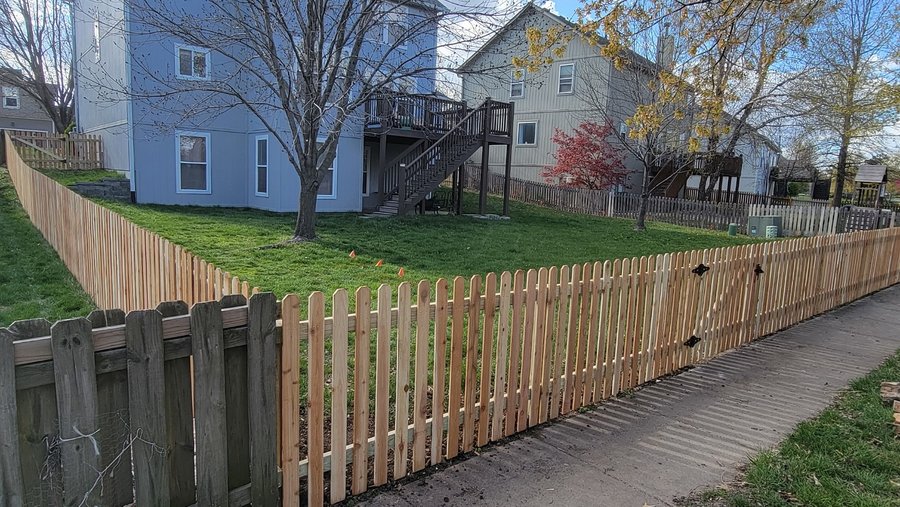 Cedar spaced picket fence along a sidewalk at a Kansas City corner lot — RKC Wood Care Pros