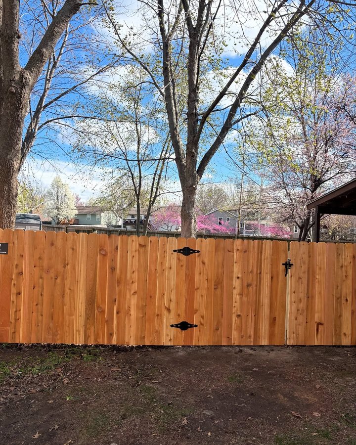 Finished cedar privacy fence install in an Olathe, Kansas backyard by RKC Wood Care Pros