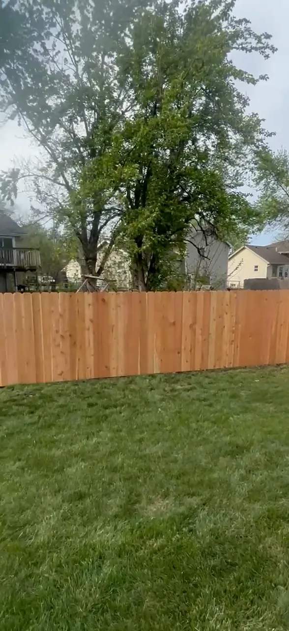 New 5 ft wood privacy fence along a Gardner, KS backyard — RKC Wood Care Pros
