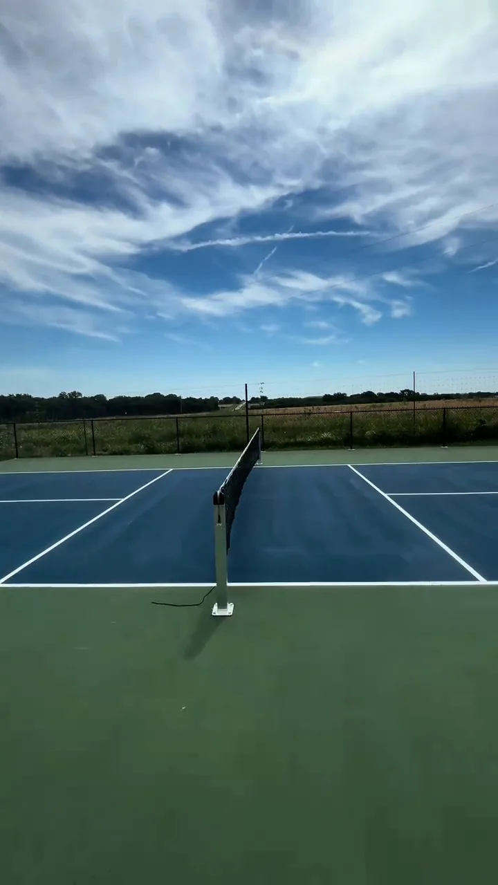 Black chain link fence around a tennis court in La Cygne, KS — RKC Wood Care Pros
