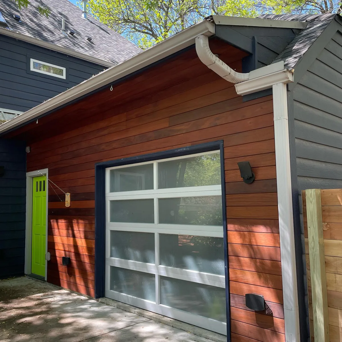 Stained cedar utility box enclosure beside HVAC unit at Kansas City, MO home