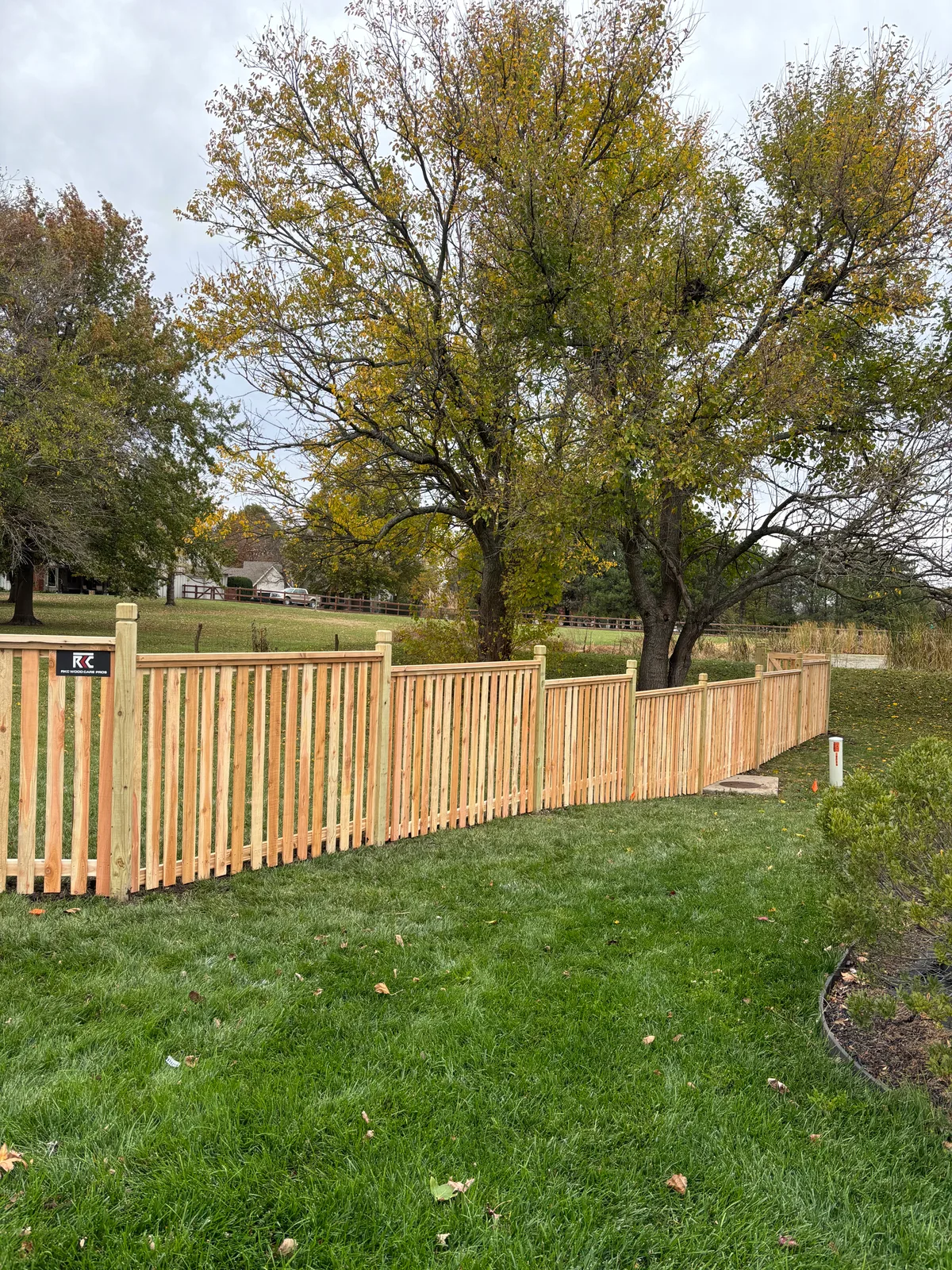 Cedar fence line detail in Gardner, KS — horizontal slat style close view