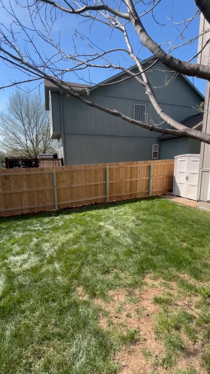 New dog-ear wood privacy fence in a Shawnee, KS backyard — RKC Wood Care Pros